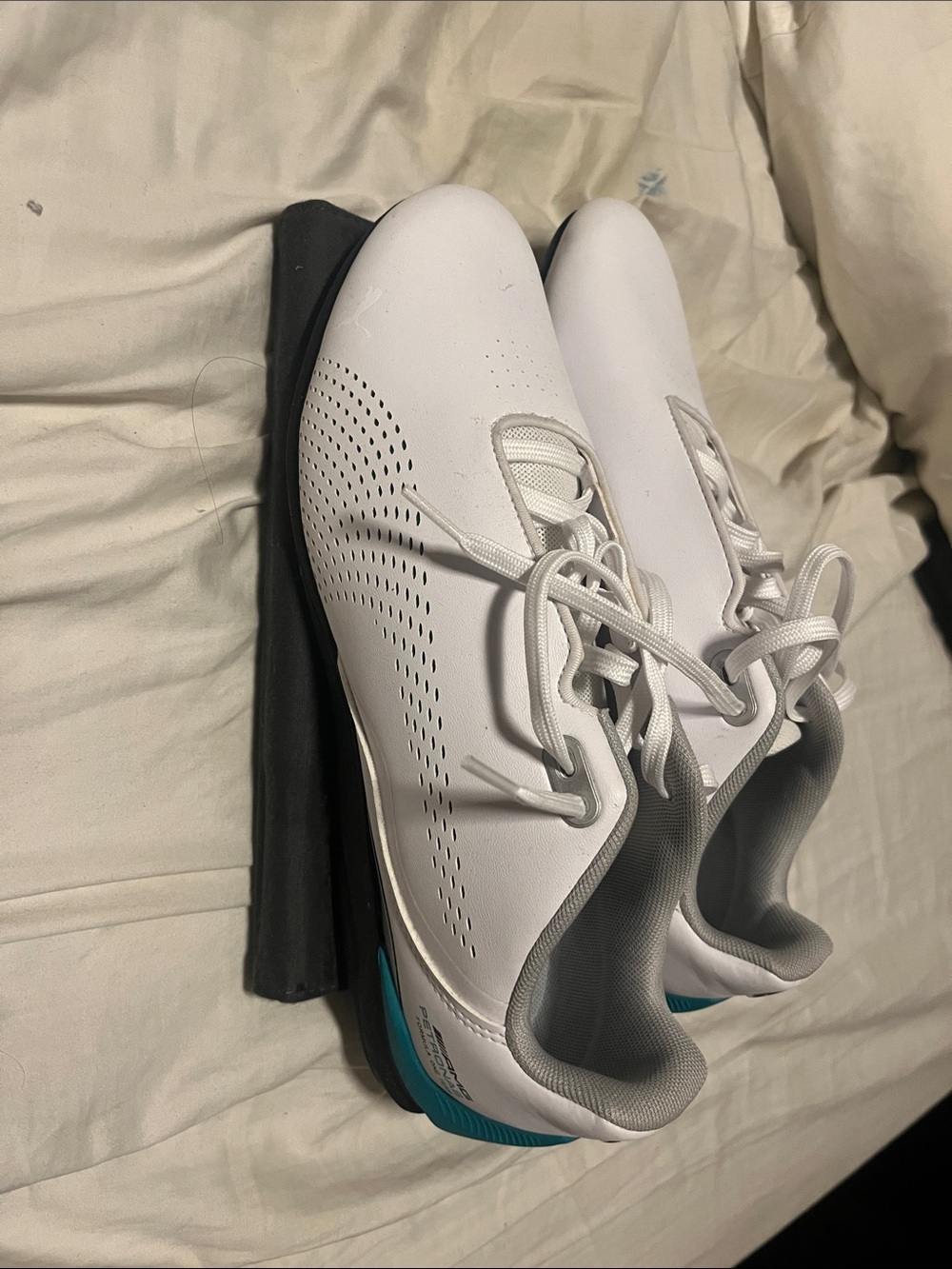 White and teal men’s Puma Drift Cat shows